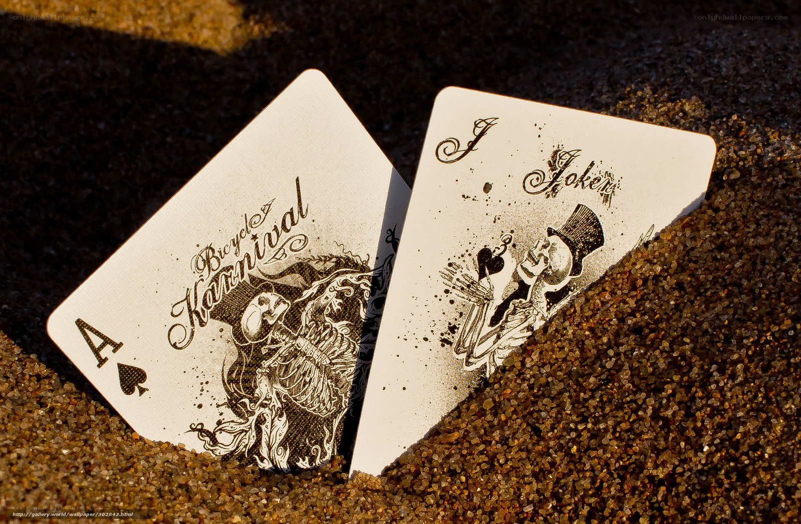 Playing cards in the sand