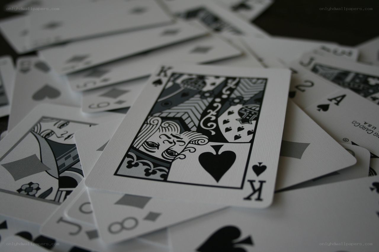 playing cards scattered on table