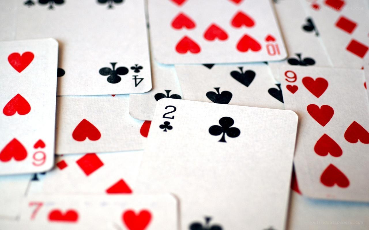playing cards scattered on table