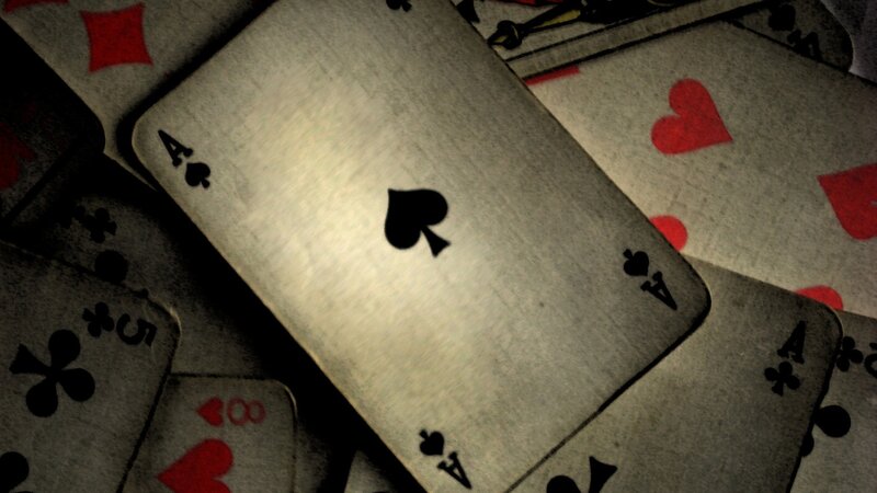 playing cards scattered on table