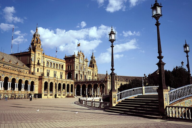 Plaza De España in Seville — Blue, Serene, Afternoon, Photograph, Building, Bridge, Lampposts
