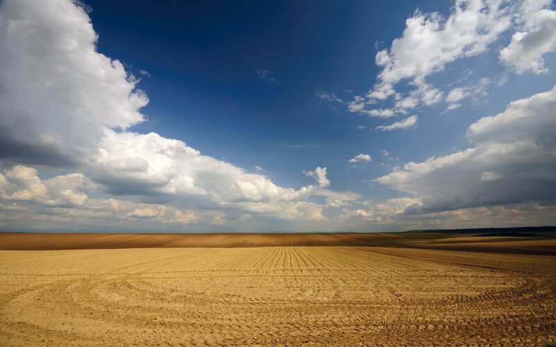 Plowed Field under Clouds — Blue, Dramatic