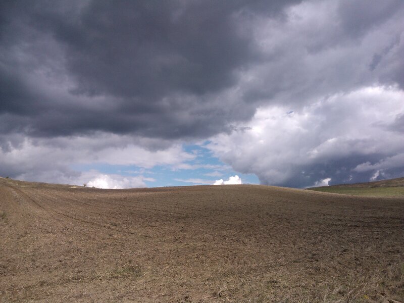 Plowed Field under Storm Clouds