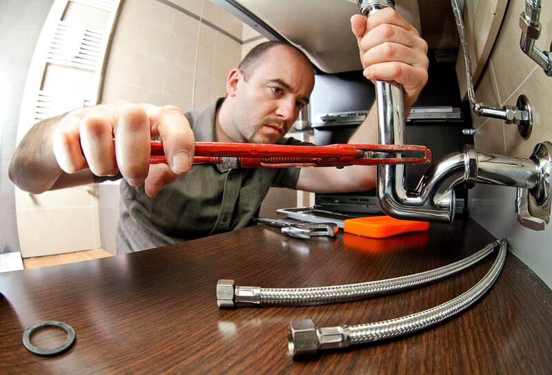 Plumber fixing a sink