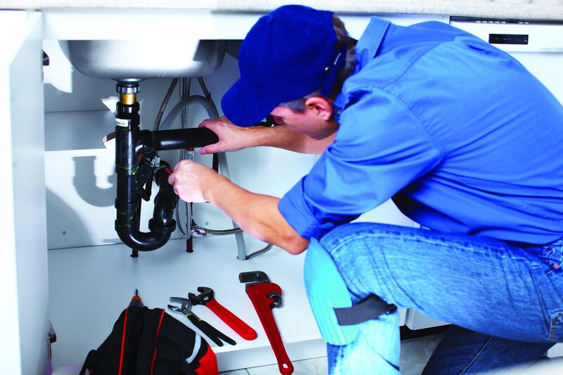 plumber fixing kitchen sink