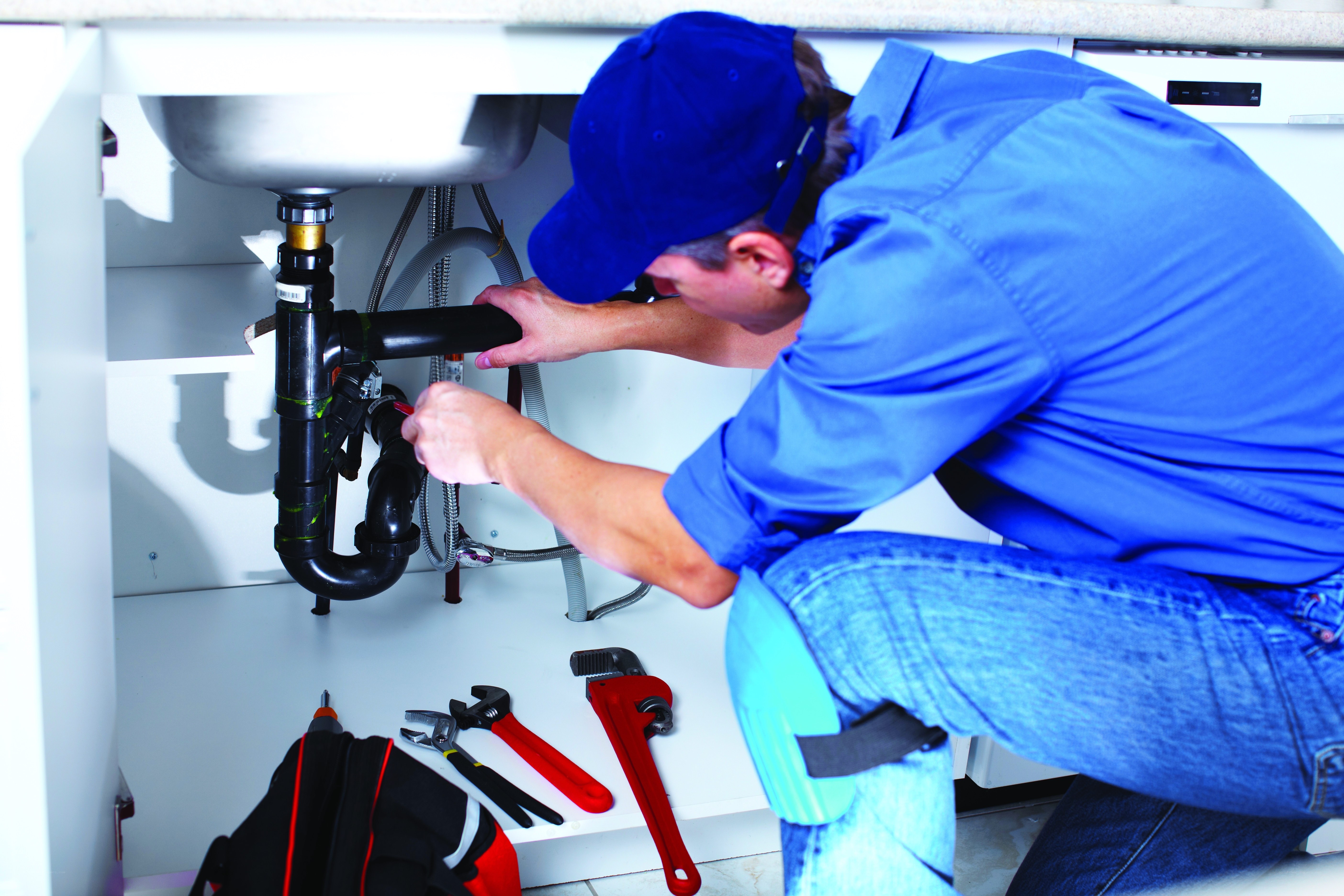 plumber fixing kitchen sink