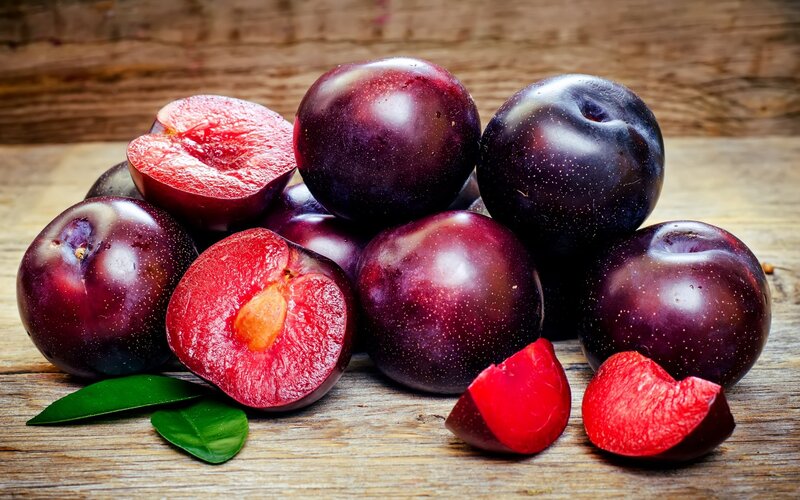 Plums on Wooden Surface