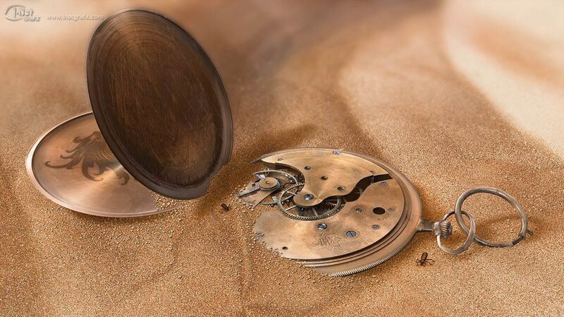 Pocket watch in the sand