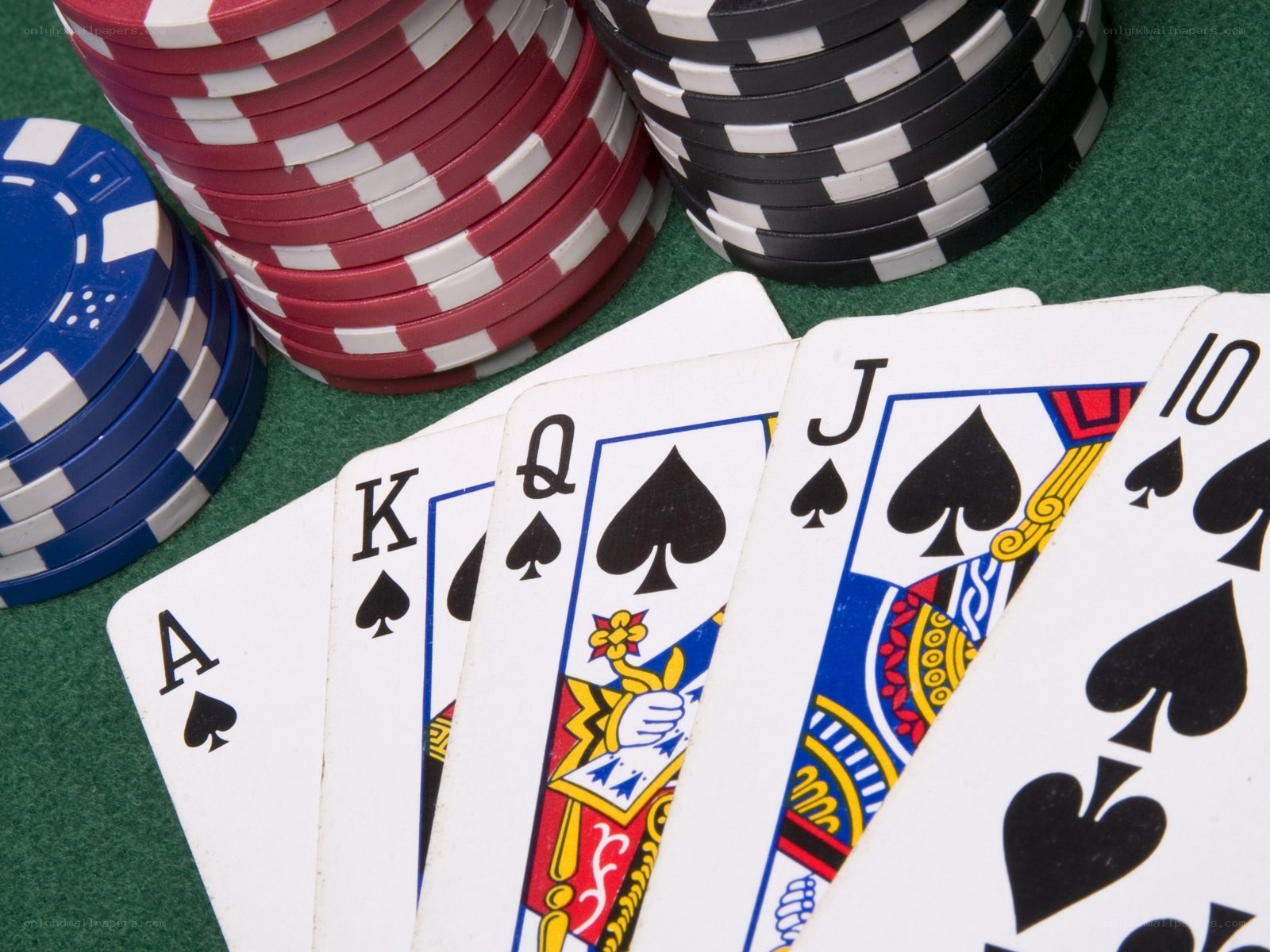 Poker cards and chips on green table