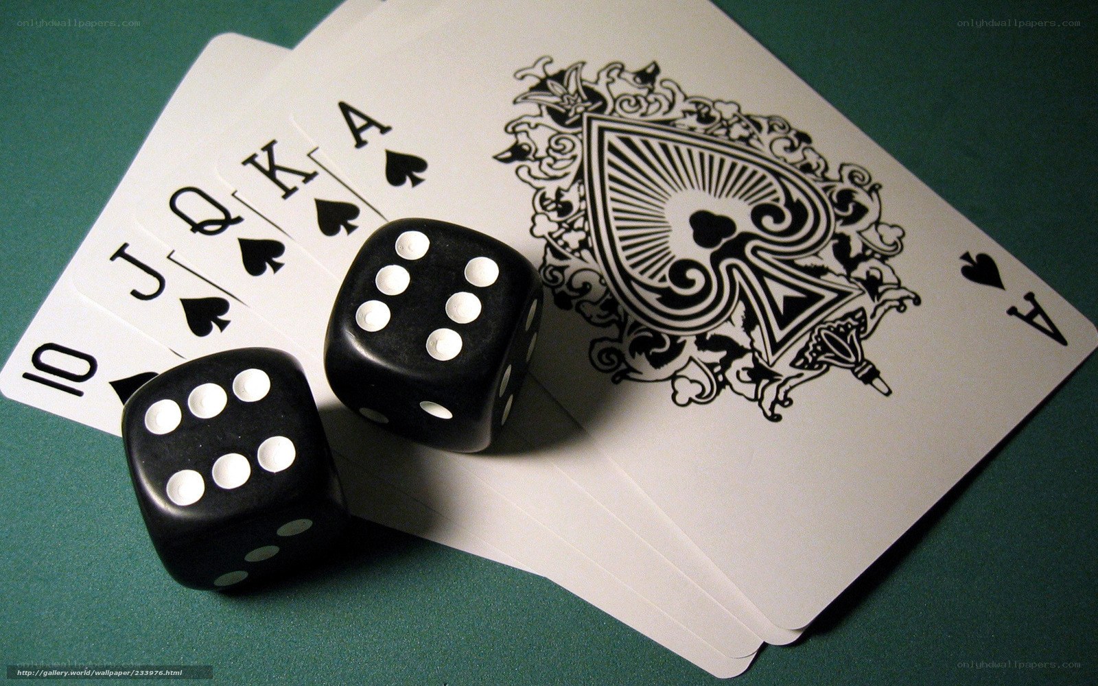 Poker cards and dice on green table