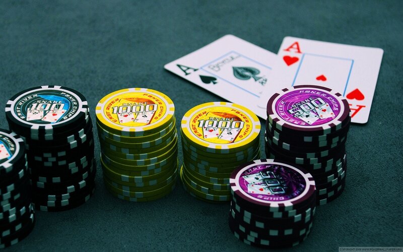 Poker chips and cards on green felt