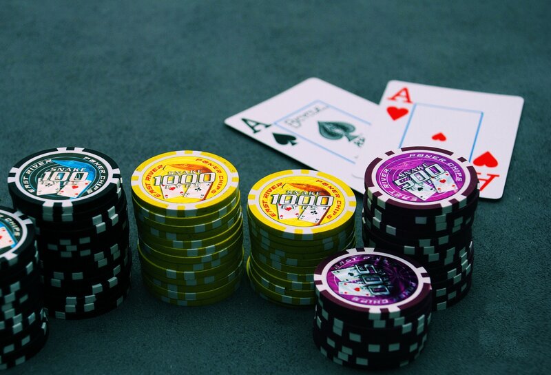 Poker chips and cards on green felt