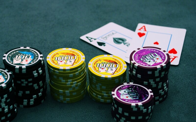 Poker chips and cards on green felt