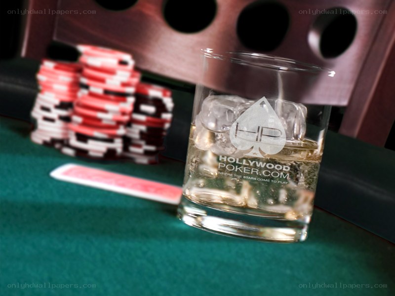 Poker chips and drink on table