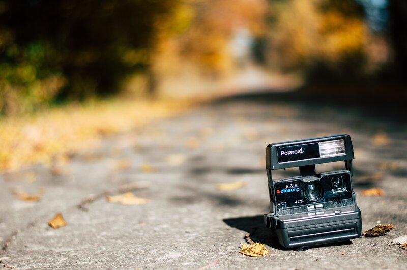Polaroid Camera on Pavement