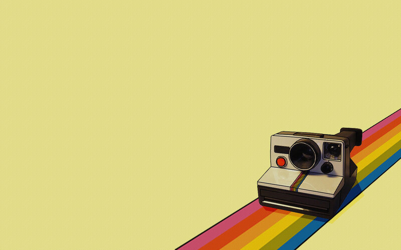 Polaroid camera on rainbow path