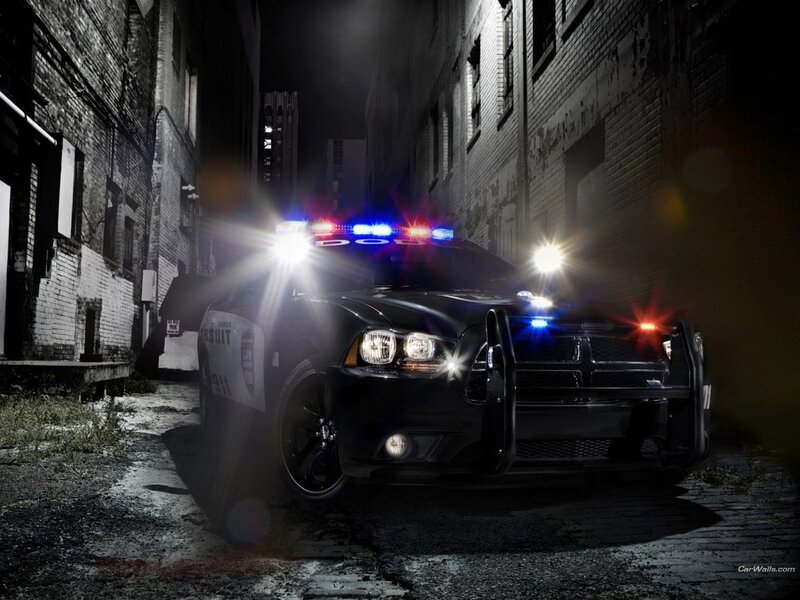 Police car in alley at night