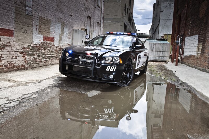 Police car in alley with reflection