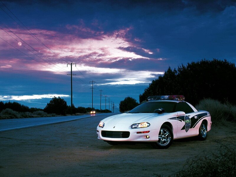 Police car on a road at dusk