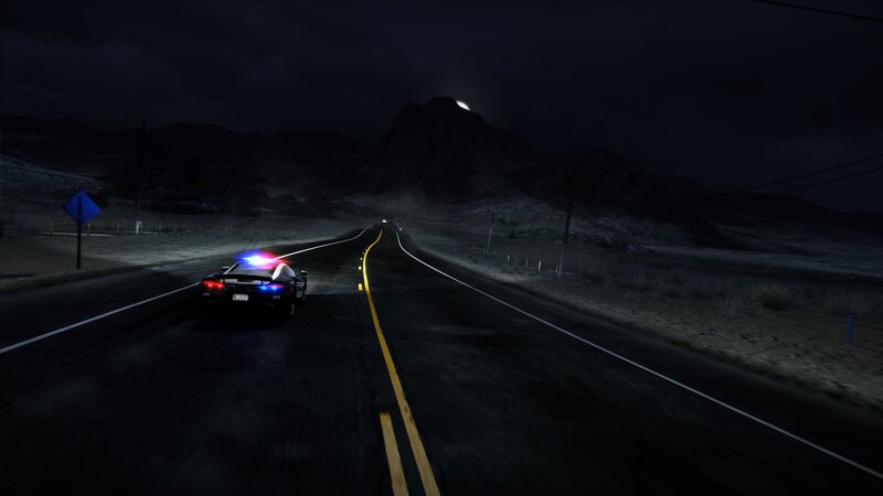 police car on desert road at night