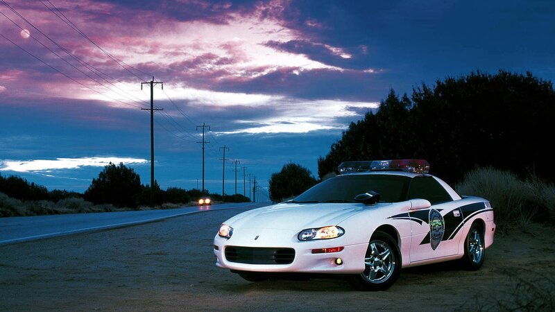 Police car on roadside at dusk