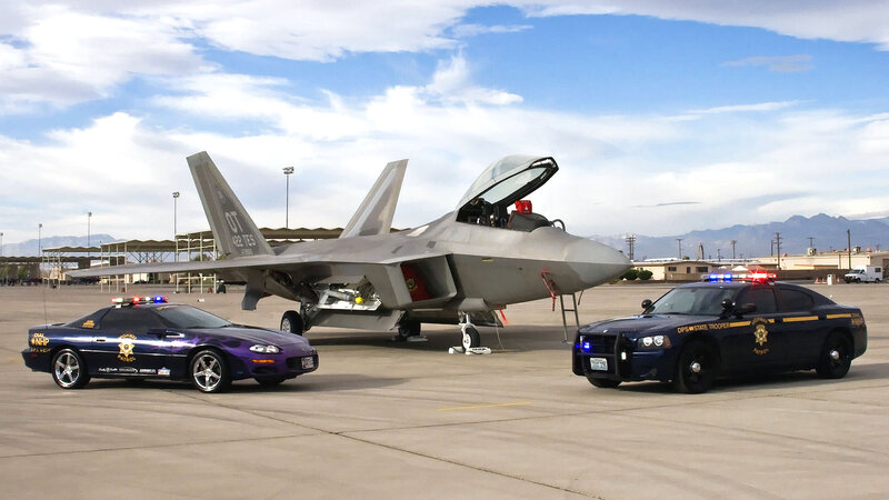 Police cars with fighter jet