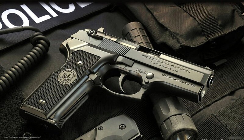 Police handgun on tactical gear