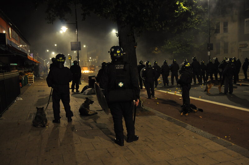 Police in riot gear at night