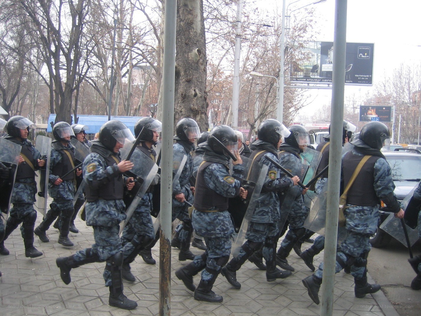 Police in riot gear marching