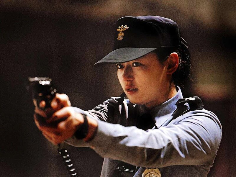 Police officer aiming a gun