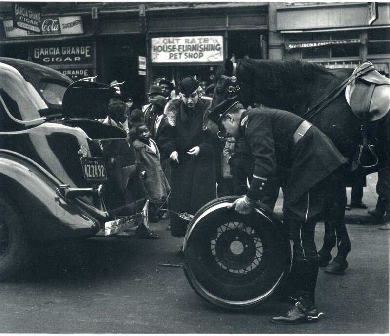 Police officer changing tire on street