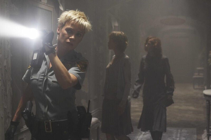 Police officer in a dark hallway