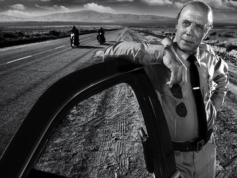 Police officer on desert road