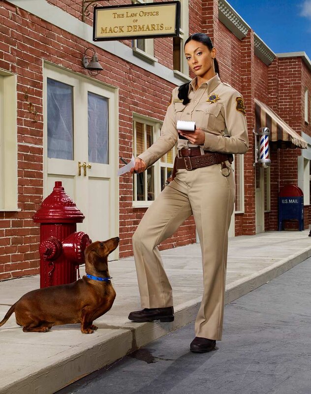 Police officer with dachshund on street