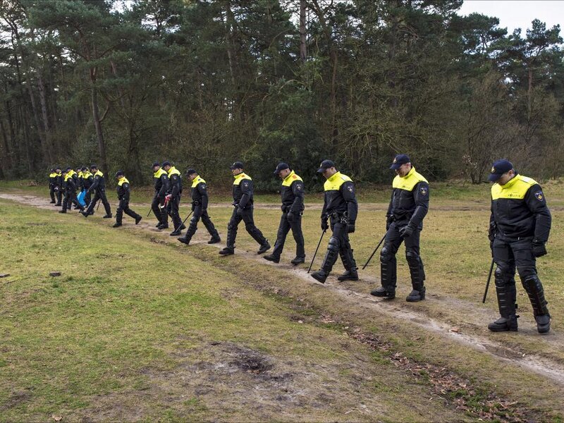 Police Officers in Forest — Black, Serious