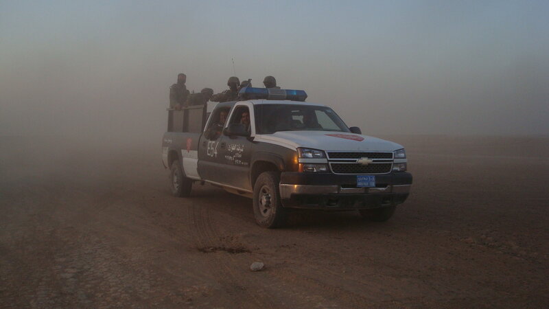 Police truck in desert sandstorm