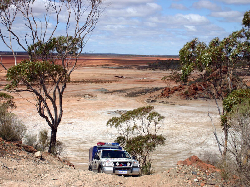 Police vehicle in arid landscape