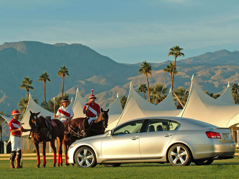 Polo players with car at event