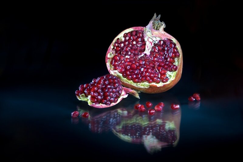 Pomegranate on dark surface