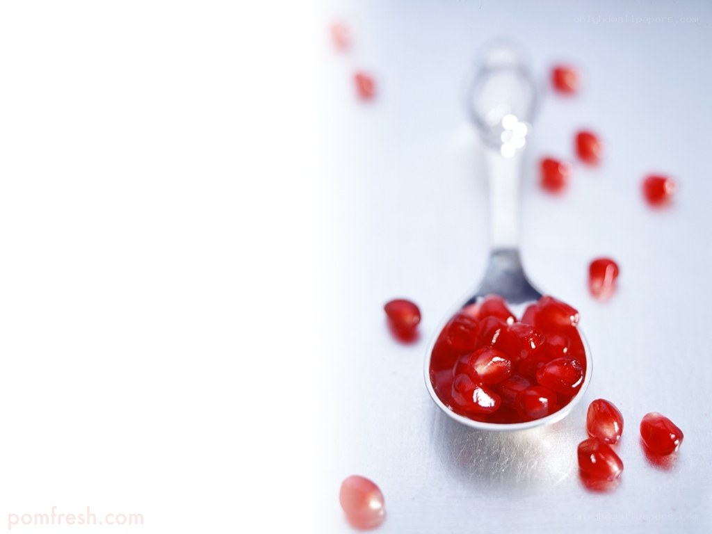 Pomegranate seeds on a spoon