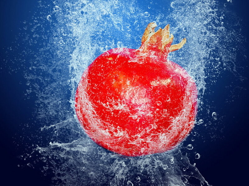 pomegranate splashing in water