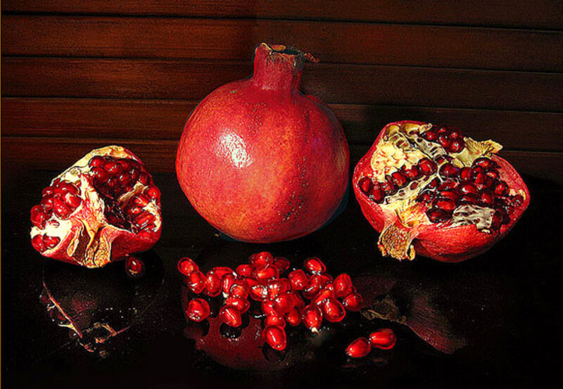 Pomegranates on dark surface