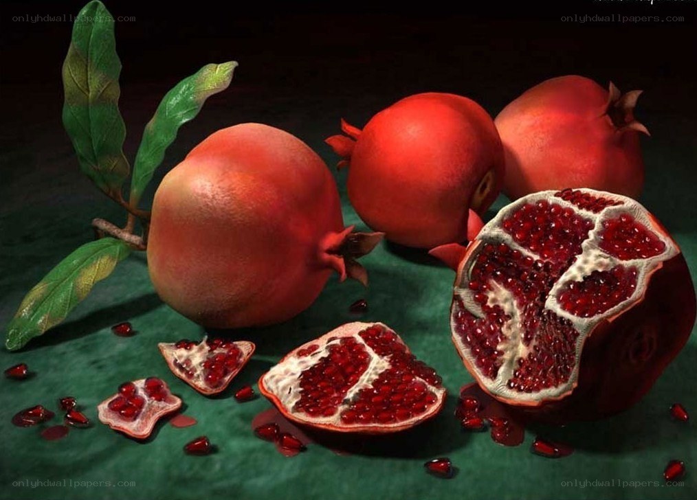 Pomegranates on green surface