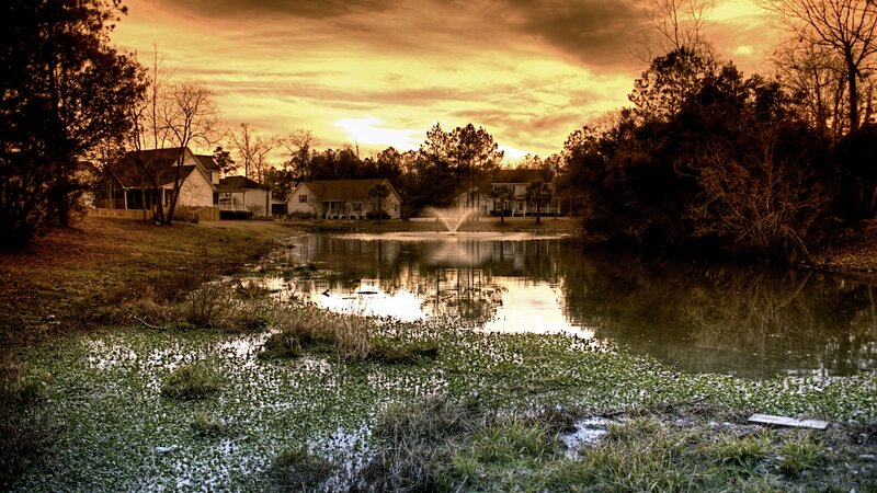 Pond with Fountain and Houses