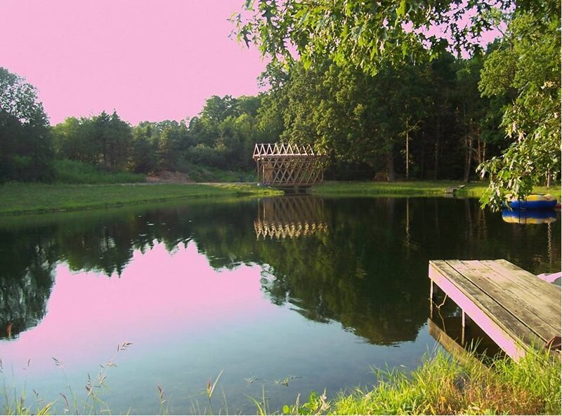 Pond with wooden dock and bridge