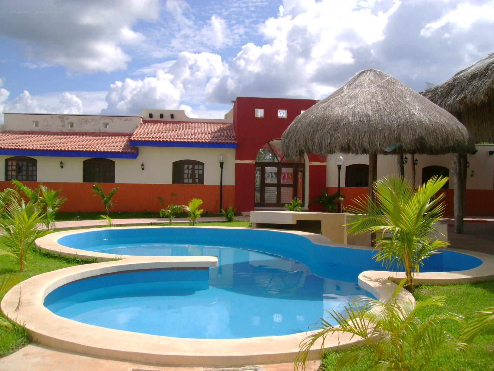 pool area at resort with thatched umbrellas