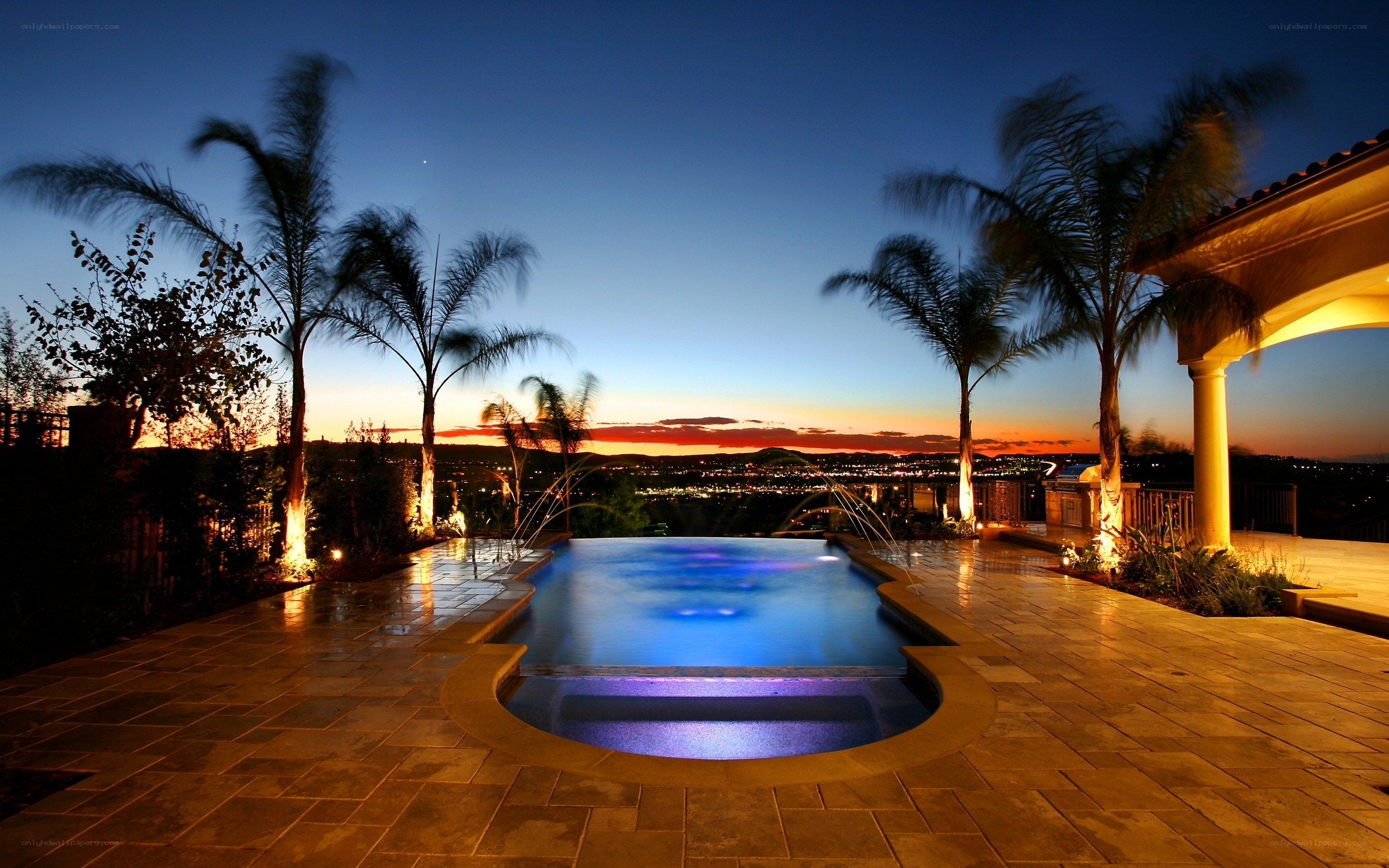 Pool at dusk with city view