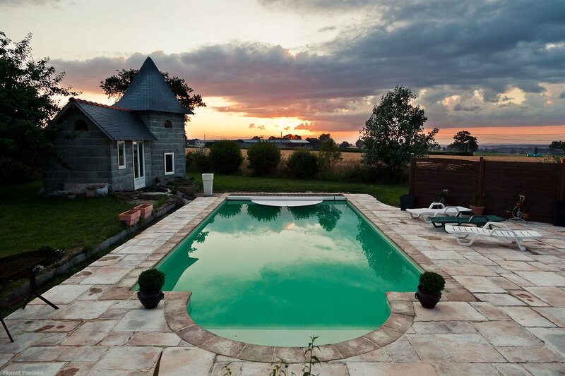 Pool at sunset with stone house