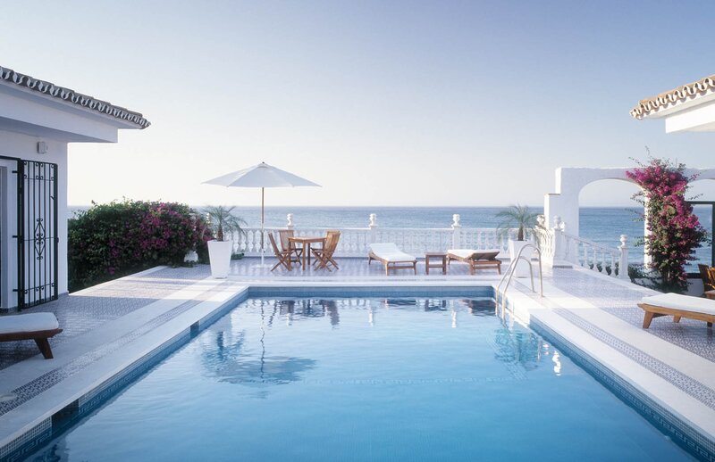 Pool Overlooking Ocean — Blue, Serene, Afternoon, Photograph, Umbrella