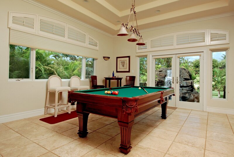 Pool table in sunroom with garden view